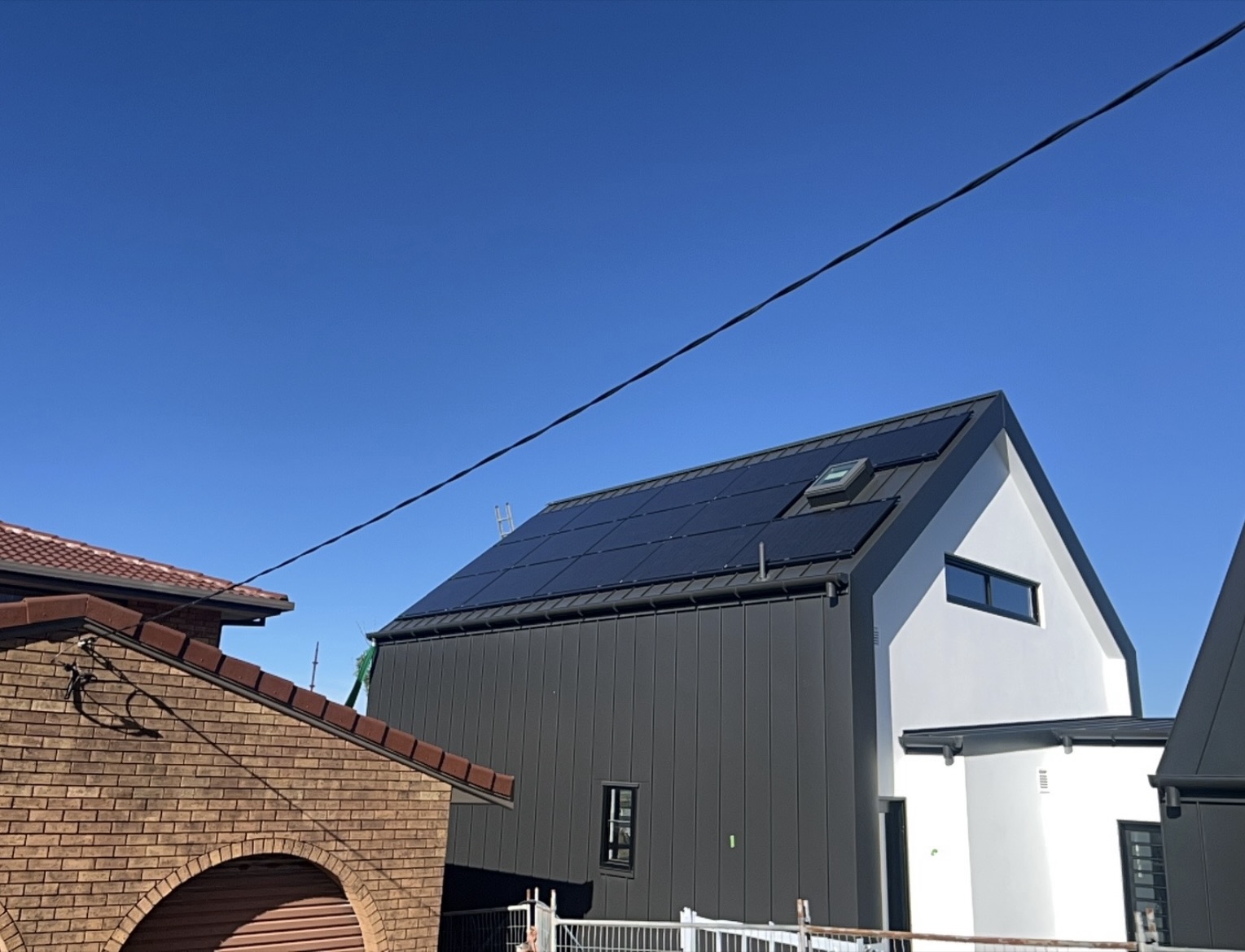 Black solar panels on a modern dark grey roof